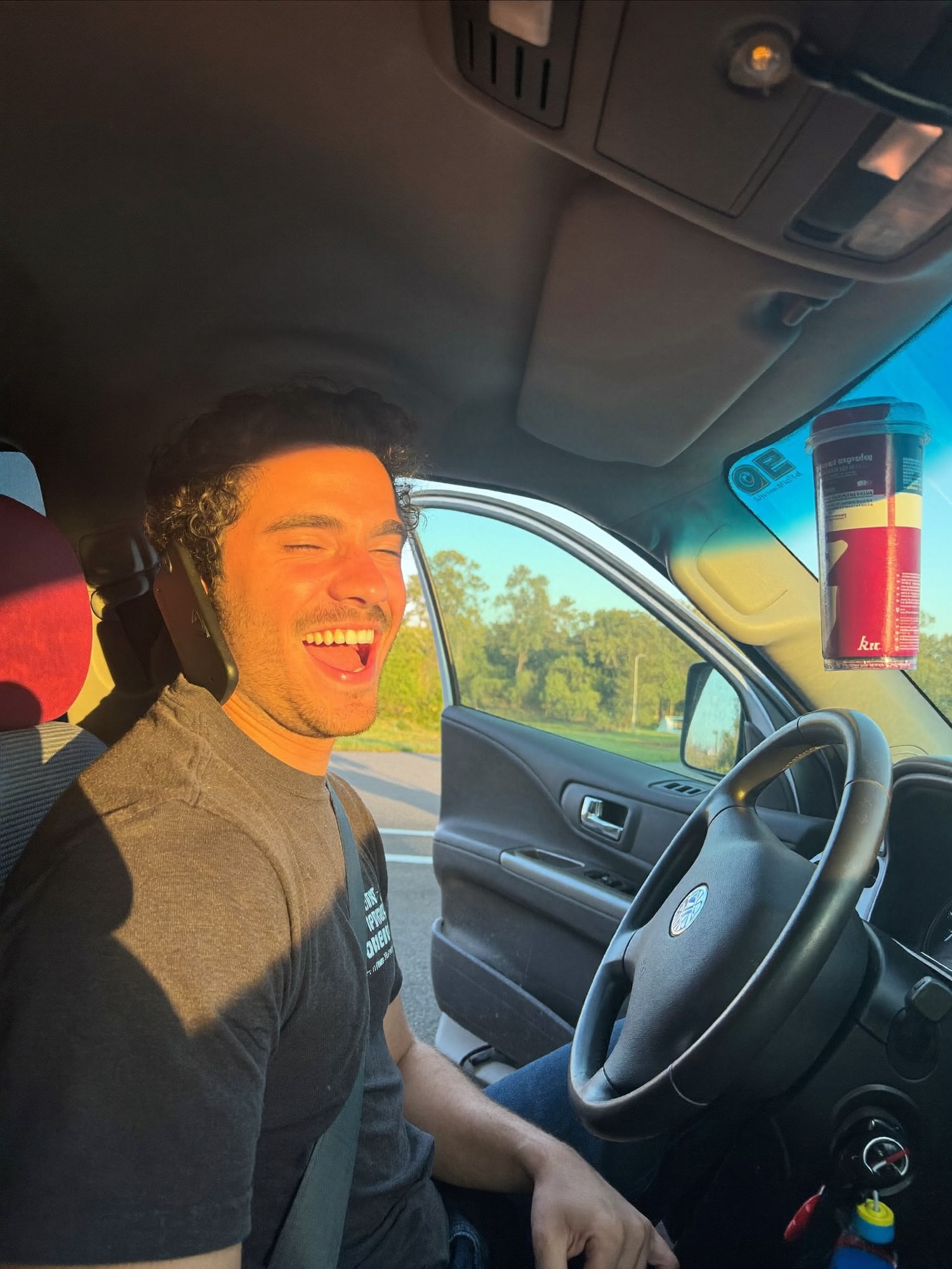 A sales manager laughing in his truck